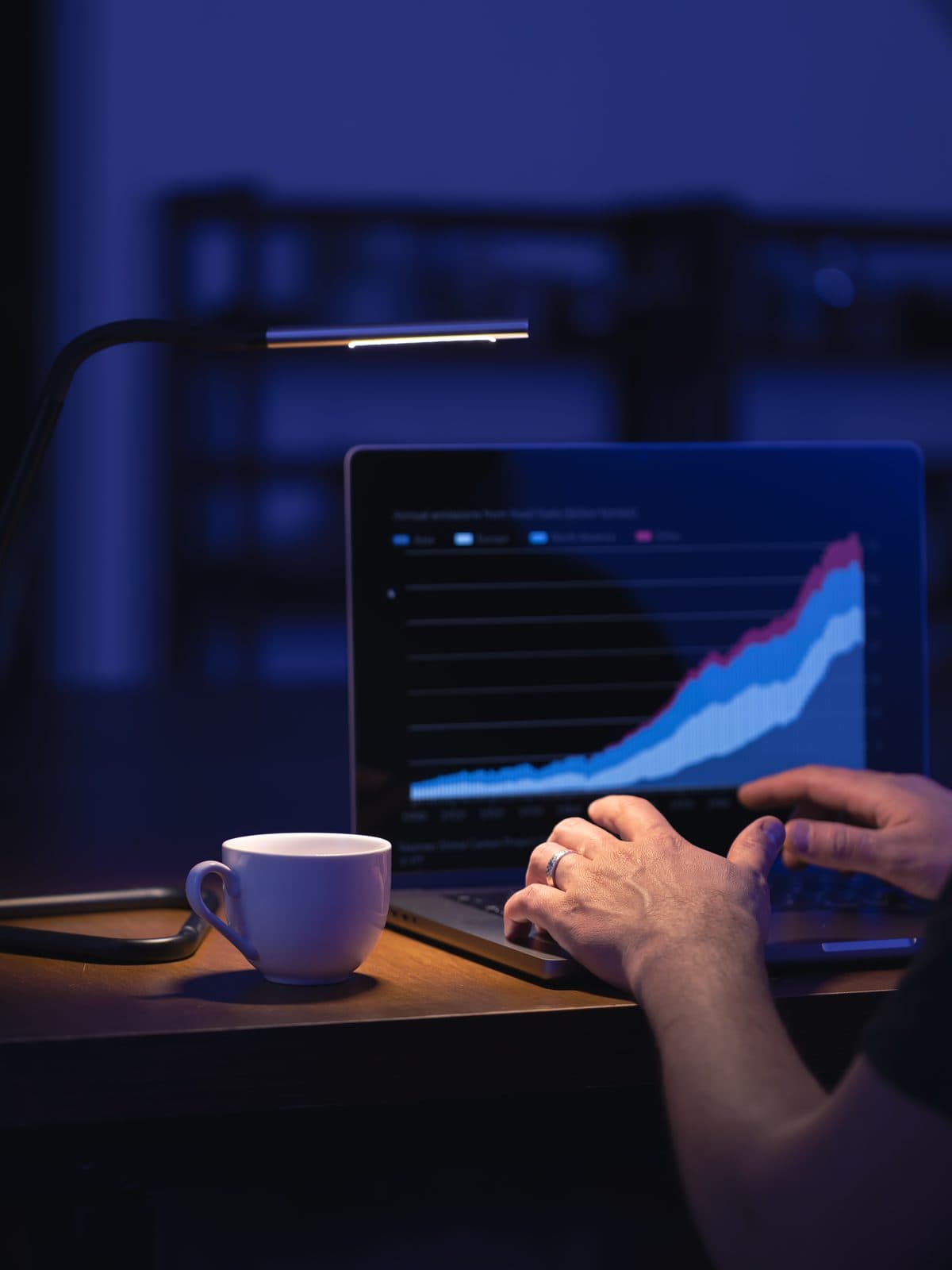 Marketer reviewing paid campaign performance charts on a laptop