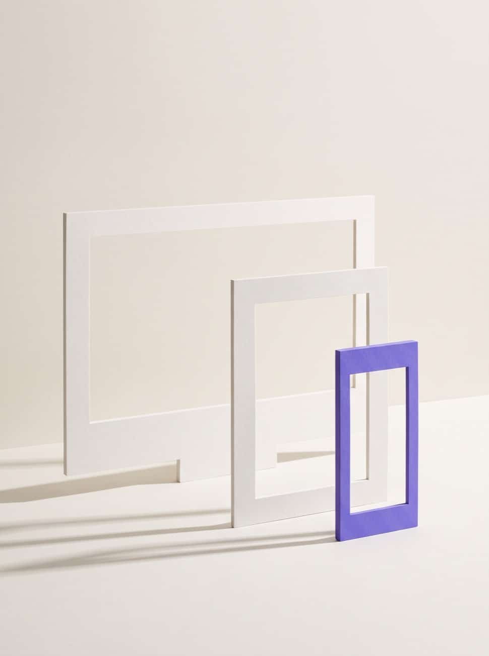 Desktop, tablet and violet phone frames standing in a row, one design adapting across screen sizes