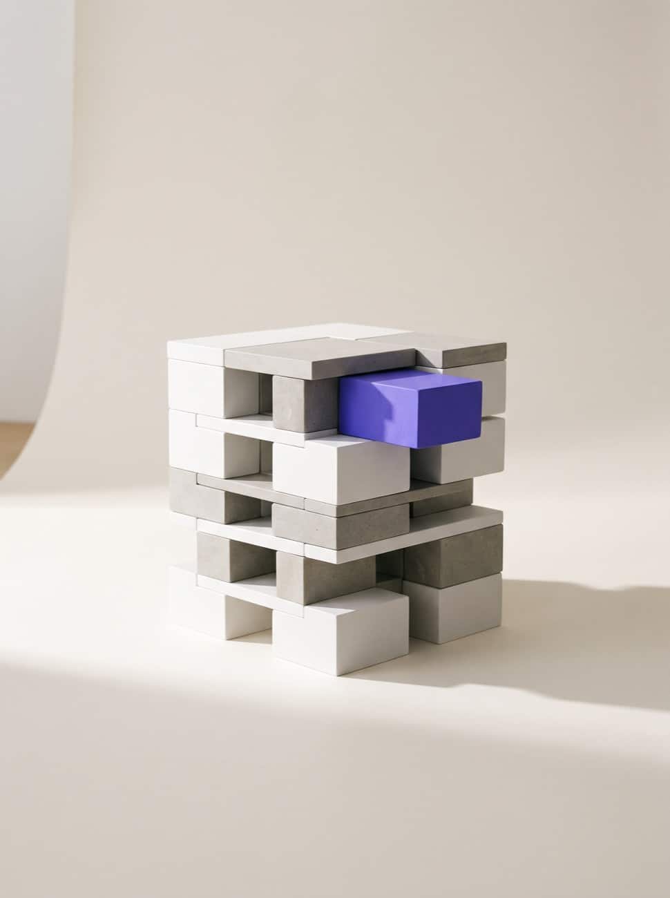 Modular white and stone blocks forming a structure, with a violet block slotted in as a new module